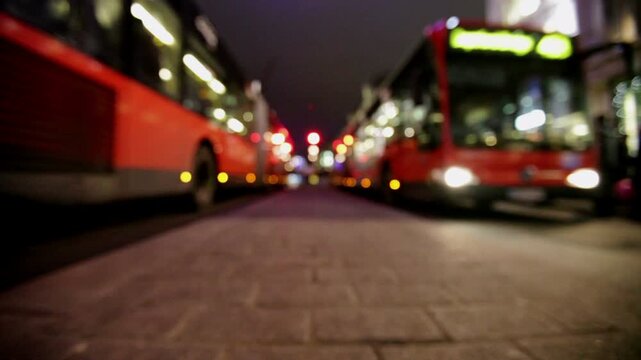 Defocussed low angle view of Oxford Street, London, at night. The deliberate blur and central perspective highlight the movement and scale of this busy shopping district at Christmas time.