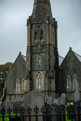 Fototapeta premium Old Stone Church and Weathered Gravestones in Snowdonia, Wales