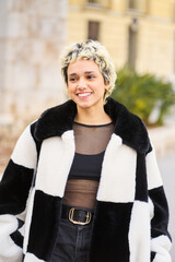 Young woman smiling wearing black white coat
