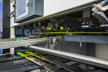 Ski boots binding to skis on an automated industrial production line in a factory