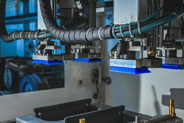 Robotic manufacturing arm with suction cups performing automated tasks in a modern factory