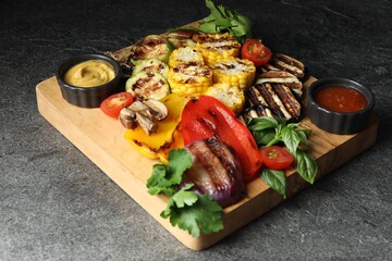 Vegetarian barbeque. Tasty grilled vegetables served on grey table, closeup
