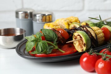 Vegetarian barbeque. Tasty grilled vegetables served on white marble table, closeup