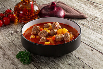 Tomato soup with meatballs and vegetables