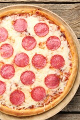 Delicious pepperoni pizza on wooden table, top view