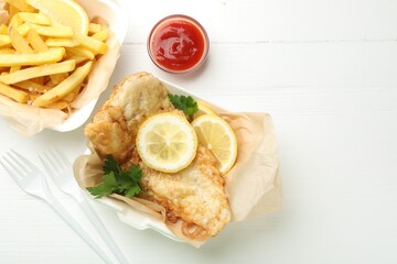 British Traditional Fish and chips served with sauce on white wooden table, flat lay. Space for text