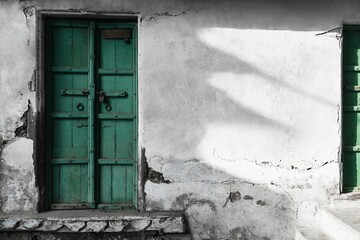 Green door, home facade wall