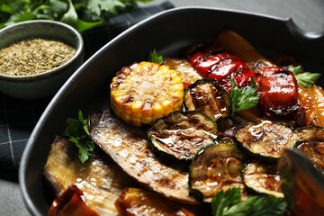 Delicious grilled vegetables with parsley in pan on table, closeup