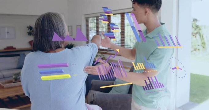 Therapist placing hands and guiding patient arm lift in therapy, with graphs monitoring progress