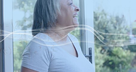 Senior woman by glass door exhaling laugh spawning waveform with formulas materializing for STEM - Powered by Adobe