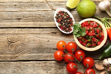 Tasty salsa and ingredients on wooden table, flat lay. Space for text
