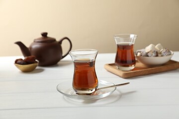 Traditional Turkish tea and sweets on white wooden table