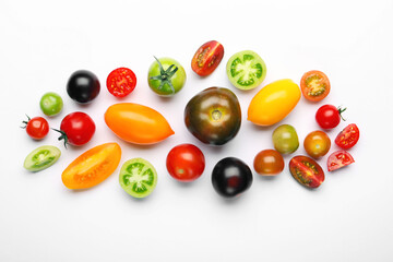 Ripe colorful tomatoes on white background, flat lay