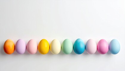 Obraz premium A Pastel Rainbow of Easter Eggs Lined Up in a Row on a White Background with Soft Lighting and Subtle Water Droplets