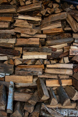 Large wood pile of chopped logs, natural wooden texture background
