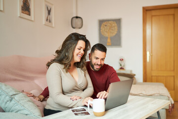 Expecting couple shopping online for baby with ultrasound