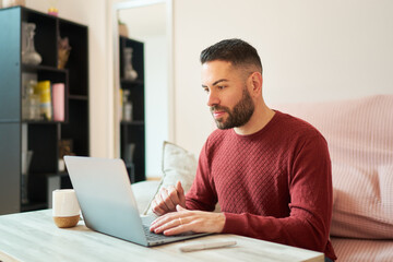 Man working from home using laptop remotely