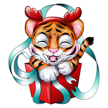 Festive Christmas smiling little tiger cub in a headband with reindeer antlers sitting in a gift red box wrapped in blue ribbons
