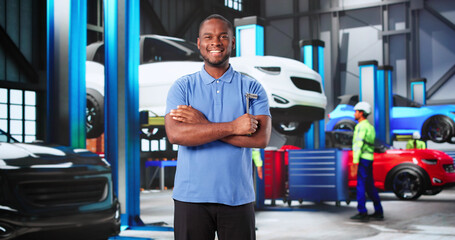 Skilled African-American Mechanic Smiling While Detailing Cars