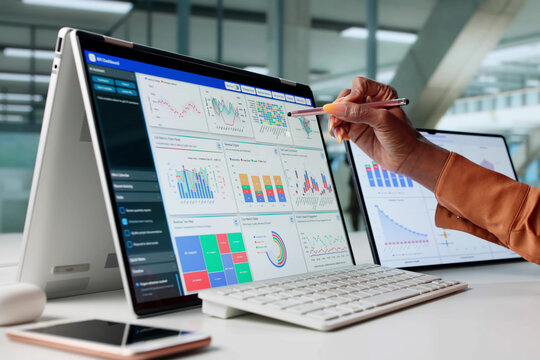 Woman Analyzing Data On Tablet Screen For KPI Dashboard - Powered by Adobe