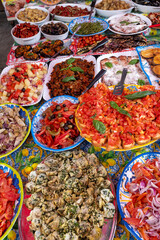 Delicious fresh cooked street food on daily food market in Palermo, Sicily, travel destination, food tourism Italy, variety of roasted, grilled fish, seafood, meat, vegetables served snacks, dish