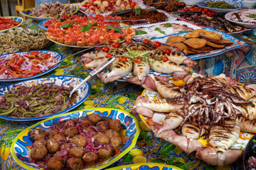 Delicious fresh cooked street food on daily food market in Palermo, Sicily, travel destination, food tourism Italy, variety of roasted, grilled fish, seafood, meat, vegetables served snacks, dish