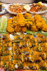 Delicious fresh cooked street food on daily food market in Palermo, Sicily, travel destination, food tourism Italy, variety of roasted, grilled fish, seafood, meat, vegetables served snacks, dish