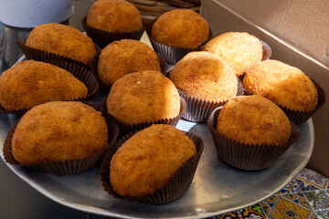 Arancini Sicilian, deep-fried rice balls made with risotto, filled with ingredients mozzarella, ragu, peas, coated in breadcrumbs fried to crispy, brown on market in Palermo, Sicily