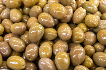 Homemade italian pickled green olives with garlic and spices on food market in Palermo, Sicily, italy