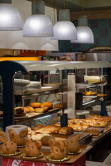 Sicilian desserts, sweets, cakes with ricotta cream, fruits, pistachio, on display in confectionery artisan shop