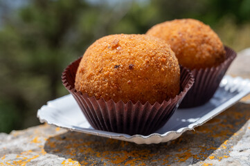 Arancini Sicilian, deep-fried rice balls made with risotto, filled with ingredients mozzarella,...