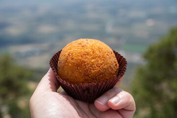 Arancini Sicilian, deep-fried rice balls made with risotto, filled with ingredients mozzarella,...