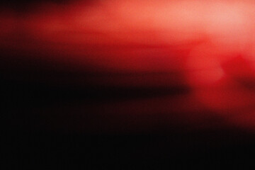 Soft red illumination with cinematic blur and grainy dust overlay, creating an elegant modern background texture for design, film, and digital art projects