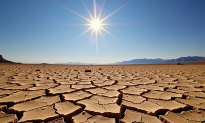 Fototapeta premium Cracked earth under a blazing sun in a desolate, dry landscape, signifying severe drought, dryland, environment, environmental issue