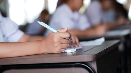 The students were doing the exams inside the classroom with stress.Assessment examination of high school students