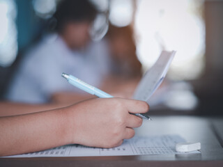 Assessment examination of high school students dressed in uniform.The students were doing the exams inside the classroom with stress