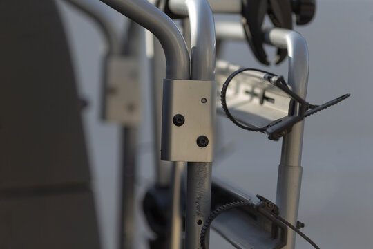 sunglasses hooked on metallic bicycle frame, sporty eyewear resting on handlebars with clear lenses and reflective coating, casual leisure vibe and toolroom detail, ideal for lifestyle or sports