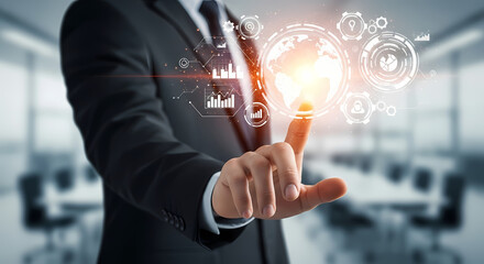 A businessman in a suit uses a digital interface with a glowing globe, symbolizing global business and technological advancement in a modern office.
