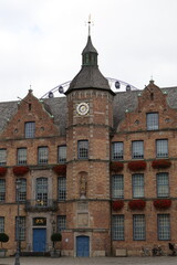 Historic Brick Town Hall Building With Clock Tower, Flower Boxes, and Blue Doors in Düsseldorf