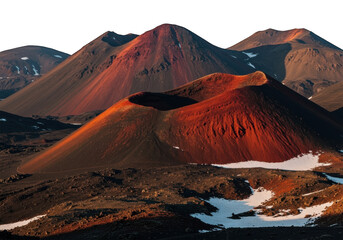 Volcanic cones in dramatic sunset light with patches of snow.