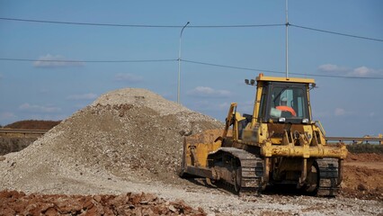 Obraz premium Bulldozer pushing gravel on construction site. Clip