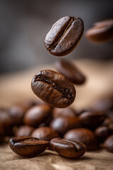 Fototapeta premium Macro levitating coffee beans over soft brown