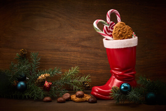 St. Nicholas Day. Red boot with sweets, spicy ginger cookies and gifts for December 6th - Powered by Adobe