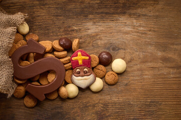 Sinterklaas, St. Nicholas bag filled with a cookies letter S of chocolate and sweets
