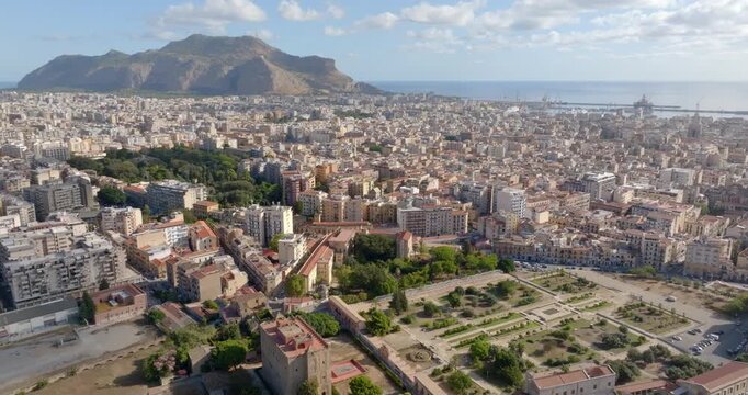 Aerial view of the city of Palermo, Sicily, Italy. In the background is the Monti Pellegrino Tower, which dominates the city and overlooks the Mediterranean Sea. In foreground there is Zisa palace.