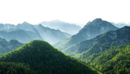 Majestic mountain range covered in verdant forests, with sunlight piercing through the misty peaks