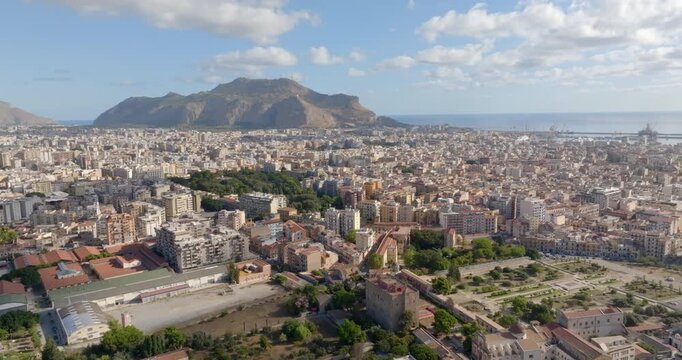 Aerial view of the city of Palermo, Sicily, Italy. In the background is the Monti Pellegrino Tower, which dominates the city and overlooks the Mediterranean Sea. In foreground there is Zisa palace.