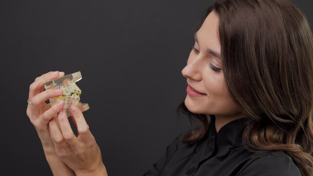 Orthopedic dentist doctor is holding teeth 3d printed model of the patient's jaw with malocclusion
