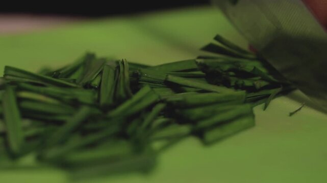 closeup shot of Cutting green leeks with knife.