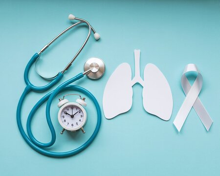 Stethoscope, lung silhouette, and white ribbon for November Awareness Mont Lung Cancer or medical check-up concept on a solid blue background  - Powered by Adobe